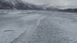 4K aerial stock footage flying near snowy Talkeetna Mountains, over icy Matanuska River Valley, Alaska Aerial Stock Footage | AK0001_0853