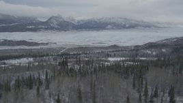 4K aerial stock footage approaching Matanuska Glacier near snow covered Chugach Mountains, during winter, Matanuska River Valley, Alaska Aerial Stock Footage | AK0001_0873