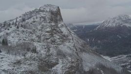 4K aerial stock footage flying up the slope of a snowy rocky peak revealing Matanuska River Valley, Alaska Aerial Stock Footage | AK0001_0877