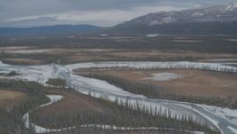 4K aerial stock footage approaching tree lined, snow covered rivers during winter in the Tazlina River Valley, Alaska Aerial Stock Footage | AK0001_0893