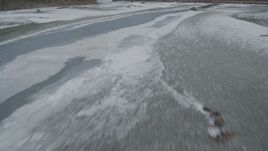 4K aerial stock footage flying low over the icy, snow covered river during winter, Tazlina River Valley, Alaska Aerial Stock Footage | AK0001_0900
