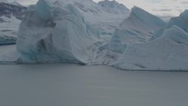 4K aerial stock footage flying over glacial ice, revealing snow covered Tazlina Glacier during winter, Tazlina Lake, Alaska Aerial Stock Footage | AK0001_0918