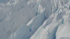 4K aerial stock footage flying over snow covered surface of the Tazlina Glacier, tilt to a bird's eye view, Alaska Aerial Stock Footage | AK0001_0931