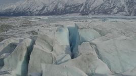 4K aerial stock footage approaching Tazlina Lake, during winter, over icy, snow covered surface of Tazlina Glacier, Alaska Aerial Stock Footage | AK0001_0938