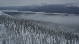 4K aerial stock footage approach Saint Anne Lake, through mist above snowy Chugach Mountains, Alaska Aerial Stock Footage | AK0001_0964