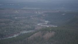 4K aerial stock footage flying over wooded gorge, forested cliff, during winter, Klutina River, Alaska Aerial Stock Footage | AK0001_0973