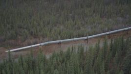 4K aerial stock footage approach and orbit pipeline emerging from ground, winter, Trans-Alaska Pipeline, Alaska Aerial Stock Footage | AK0001_0991