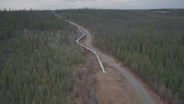 4K aerial stock footage orbiting pipeline emerging from ground, winter, Trans-Alaska Pipeline, Alaska Aerial Stock Footage | AK0001_0992