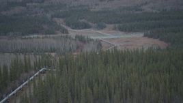 4K aerial stock footage approaching pipeline spanning Tazlina River, winter, Trans-Alaska Pipeline, Alaska Aerial Stock Footage | AK0001_1008