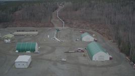 4K aerial stock footage fly over buildings pipeline rising from ground, winter, Trans-Alaska Pipeline, Alaska Aerial Stock Footage | AK0001_1010