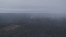 4K aerial stock footage flying by forest in the Alaskan Wilderness during a rain storm Aerial Stock Footage | AK0001_1018