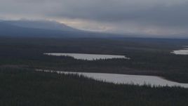 4K aerial stock footage small, snow covered lakes in the woods, Alaskan Wilderness Aerial Stock Footage | AK0001_1030