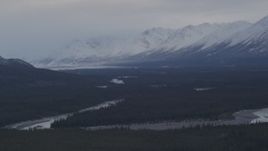 4K aerial stock footage flying alongside Tazlina River, forest and snow capped mountains, Alaska Aerial Stock Footage | AK0001_1046