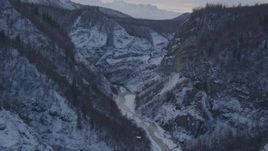 4K aerial stock footage following river at bottom of snow covered canyon, Talkeetna Mountains, Alaska Aerial Stock Footage | AK0001_1068
