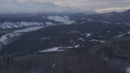 4K aerial stock footage a snowy, wooded slope, revealing Sutton, Matanuska River Valley, Alaska Aerial Stock Footage | AK0001_1074