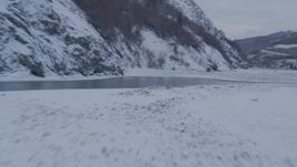 4K aerial stock footage racing low over surface of Matanuska River in snow covered ground, Alaska Aerial Stock Footage | AK0001_1082