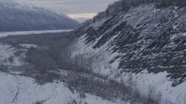 4K aerial stock footage ascending a snow covered, tree topped cliff, Matanuska River Valley, Alaska Aerial Stock Footage | AK0001_1088