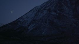 4K aerial stock footage the moon over the snow covered Chugach Mountains at night, Alaska Aerial Stock Footage | AK0001_1113