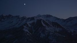 4K aerial stock footage the moon over the snow covered Chugach Mountains at night, Alaska Aerial Stock Footage | AK0001_1123