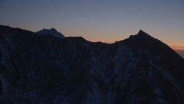4K aerial stock footage flying toward the snow covered Chugach Mountains at twilight, Alaska Aerial Stock Footage | AK0001_1127