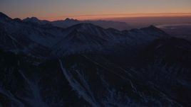 4K aerial stock footage flying toward snow covered ranges in the Chugach Mountains at twilight, Alaska Aerial Stock Footage | AK0001_1130