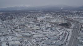 4K aerial stock footage following Glenn Highway through snow covered Anchorage, Alaska Aerial Stock Footage | AK0001_1148