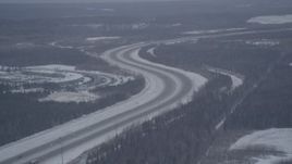 4K aerial stock footage Glenn Highway winding past snowy Bryant Army Heliport, Anchorage, Alaska Aerial Stock Footage | AK0001_1156