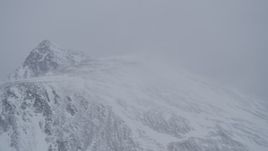 4K aerial stock footage wind blowing snow off mountain ridge, Chugach Mountains, Alaska Aerial Stock Footage | AK0001_1208