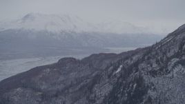4K aerial stock footage fly around snowy, wooded slopes, Knik River Valley, Chugach Mountains, Alaska Aerial Stock Footage | AK0001_1213