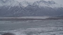 4K aerial stock footage flying toward lake, snow capped mountains in the Knik River Valley, Alaska Aerial Stock Footage | AK0001_1218