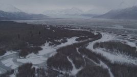 4K aerial stock footage flying over snow covered brush and rivers, Knik River Valley, Alaska Aerial Stock Footage | AK0001_1227