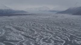 4K aerial stock footage flying over snowy Knik River Valley to Knik Glacier, Chugach Mountains, Alaska Aerial Stock Footage | AK0001_1228
