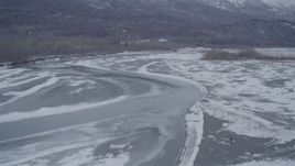 4K aerial stock footage flying over a river in the snow covered Knik River Valley, Alaska Aerial Stock Footage | AK0001_1252