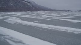 4K aerial stock footage flying over a river in the snow covered Knik River Valley, Alaska Aerial Stock Footage | AK0001_1254