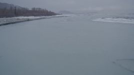 4K aerial stock footage flying over a river and sheets of ice in snow, Knik River Valley, Alaska Aerial Stock Footage | AK0001_1258