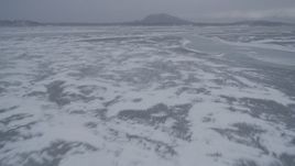4K aerial stock footage flying over frozen ground and rivers with ice sheets, Knik River Valley, Alaska Aerial Stock Footage | AK0001_1262