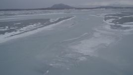 4K aerial stock footage following a river over ice sheets, Knik River Valley, Alaska in snow Aerial Stock Footage | AK0001_1263