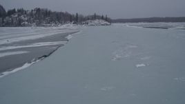4K aerial stock footage following a river with ice sheets, Knik River Valley, Alaska in winter Aerial Stock Footage | AK0001_1265