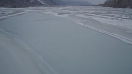 4K aerial stock footage following an icy river over frozen banks, Butte, Alaska Aerial Stock Footage | AK0001_1275