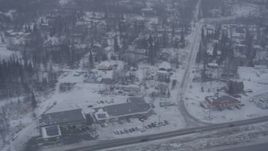 4K aerial stock footage flying by neighborhoods, reveal Glenn Highway, falling snow, Eagle River, Alaska Aerial Stock Footage | AK0001_1311