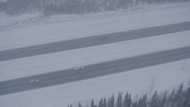 4K aerial stock footage light traffic on Glenn Highway in falling snow, Anchorage, Alaska Aerial Stock Footage | AK0001_1317