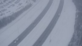 4K aerial stock footage light traffic on Glenn Highway in falling snow, Anchorage, Alaska Aerial Stock Footage | AK0001_1318