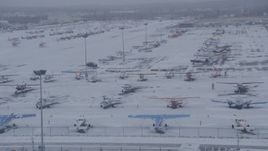 4K aerial stock footage airplanes parked on snowy runway at Merrill Field, Anchorage, Alaska Aerial Stock Footage | AK0001_1326