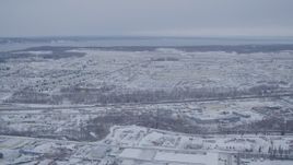 4K aerial stock footage flying past snow covered Elmendorf Air Force Base, Anchorage, Alaska Aerial Stock Footage | AK0001_1330