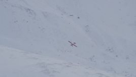 4K aerial stock footage tilting with airplane flying over snow covered slope, Chugach Mountains, Alaska Aerial Stock Footage | AK0001_1349