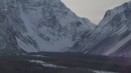 4K aerial stock footage the woods at the base of the snow covered Chugach Mountains, Alaska Aerial Stock Footage | AK0001_1363