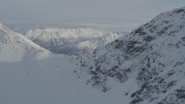 4K aerial stock footage flying over snowy mountain ridge in the Chugach Mountains, Alaska Aerial Stock Footage | AK0001_1369