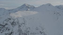 4K aerial stock footage flying over a snowy ridge toward Chugach Mountains, Alaska Aerial Stock Footage | AK0001_1371