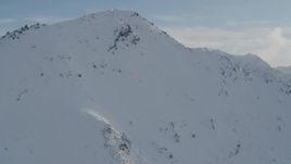 4K aerial stock footage flying over snowy mountain summit, Chugach Mountains, Alaska Aerial Stock Footage | AK0001_1372