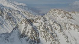 4K aerial stock footage flying toward rocky, snow covered mountain summit, Chugach Mountains, Alaska Aerial Stock Footage | AK0001_1379